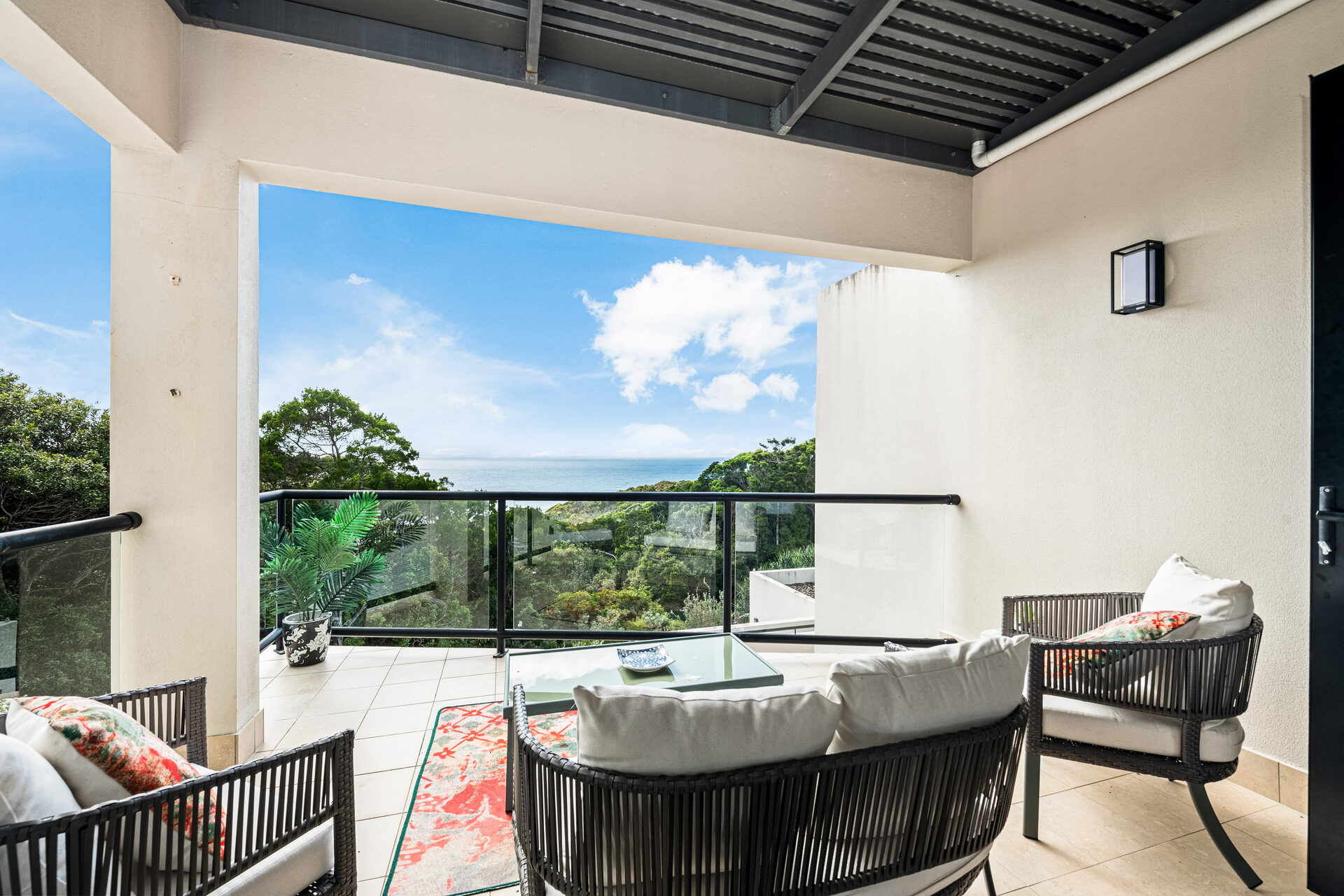 Covered deck with lounge chairs and ocean views