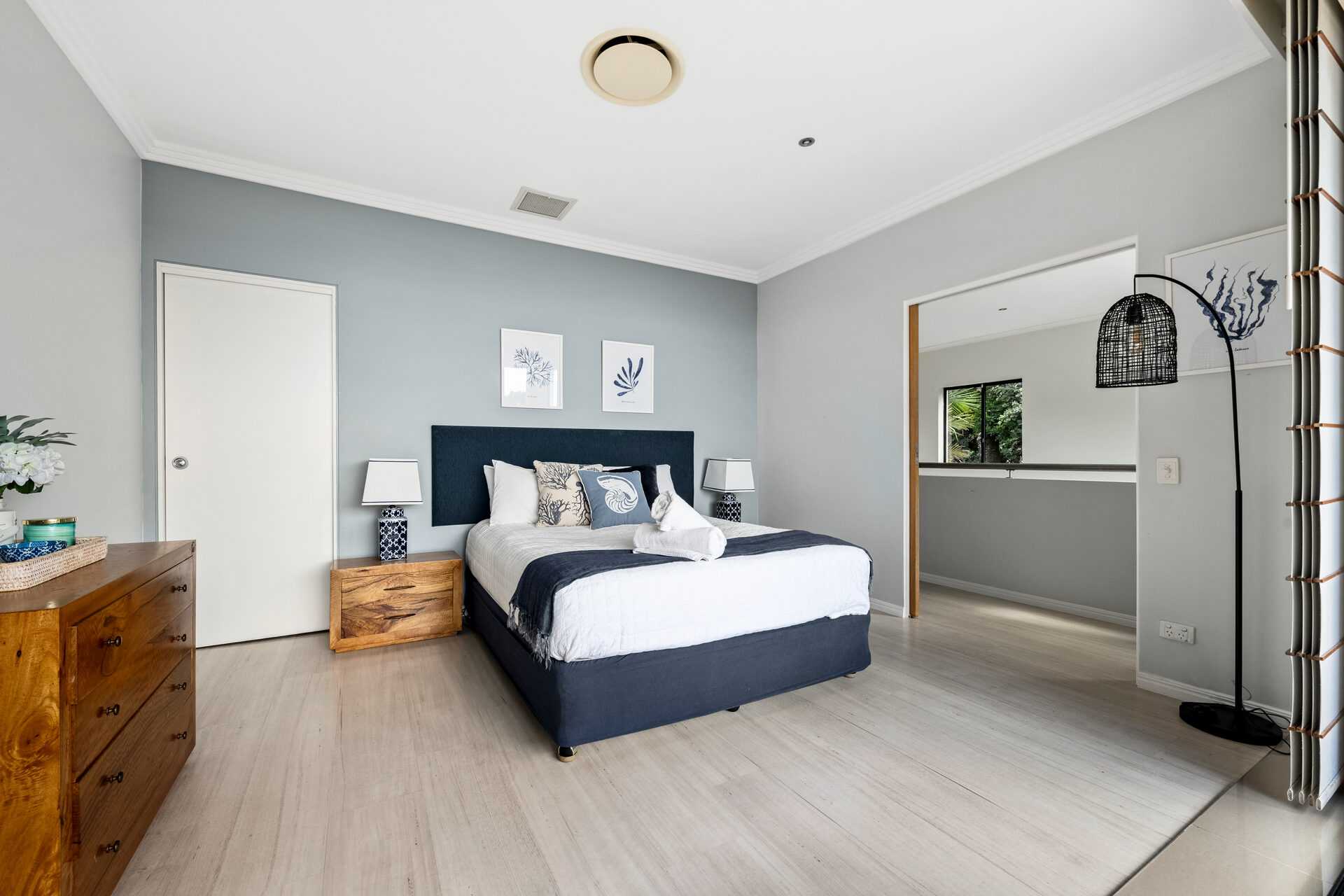 Master bedroom with navy accent wall and ensuite