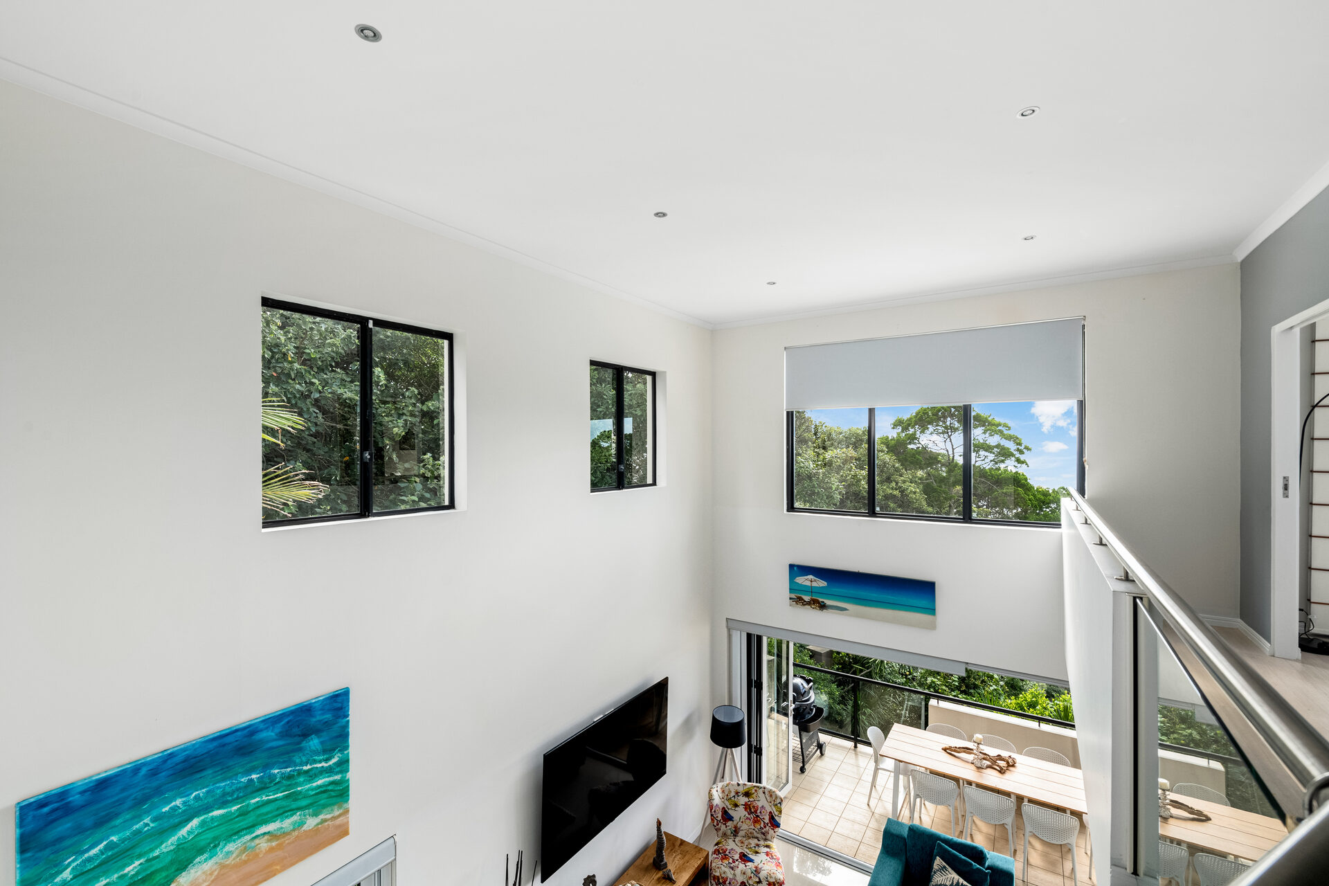 Upper level view of living space showing architectural height