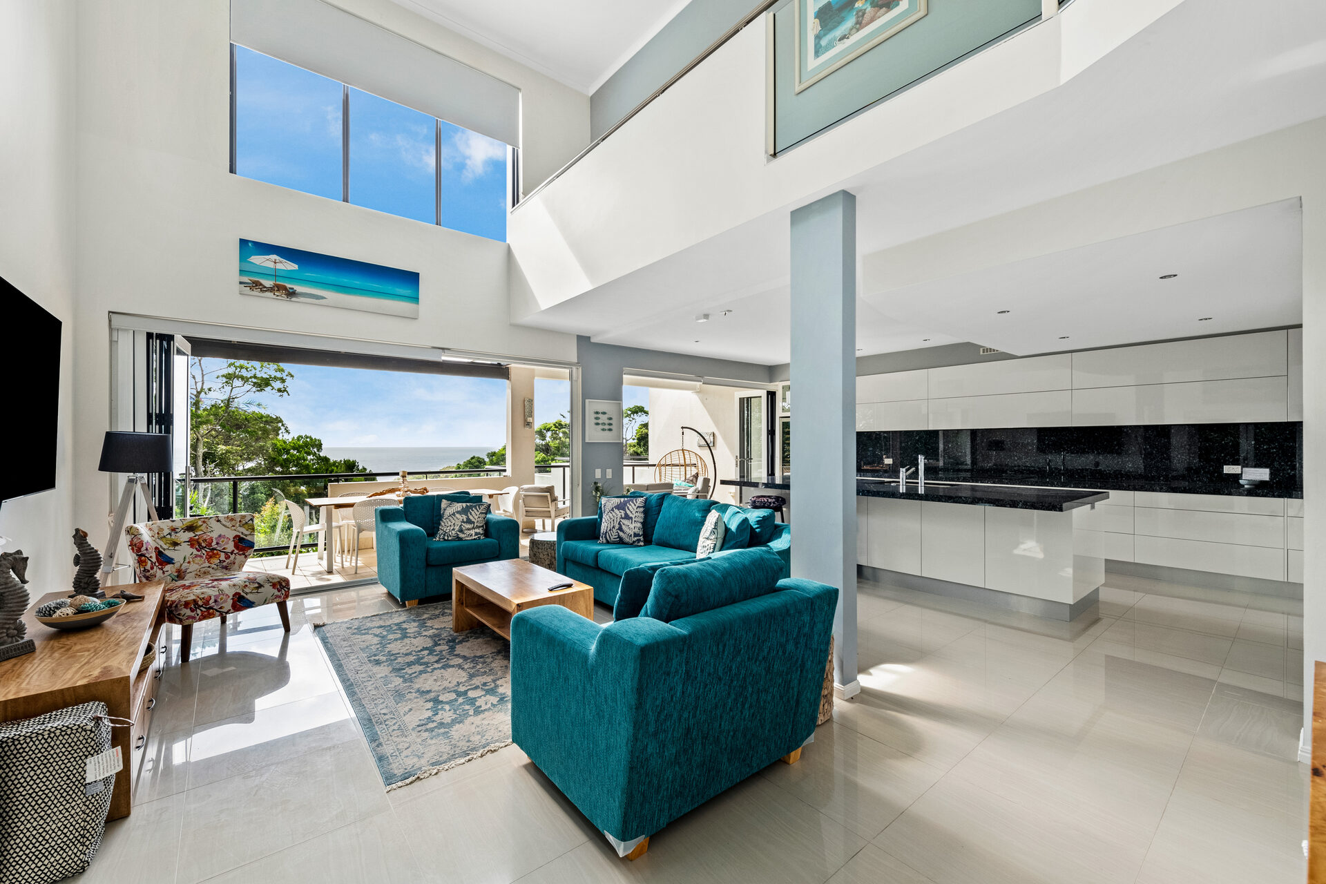Open-plan living with double-height ceilings and ocean views