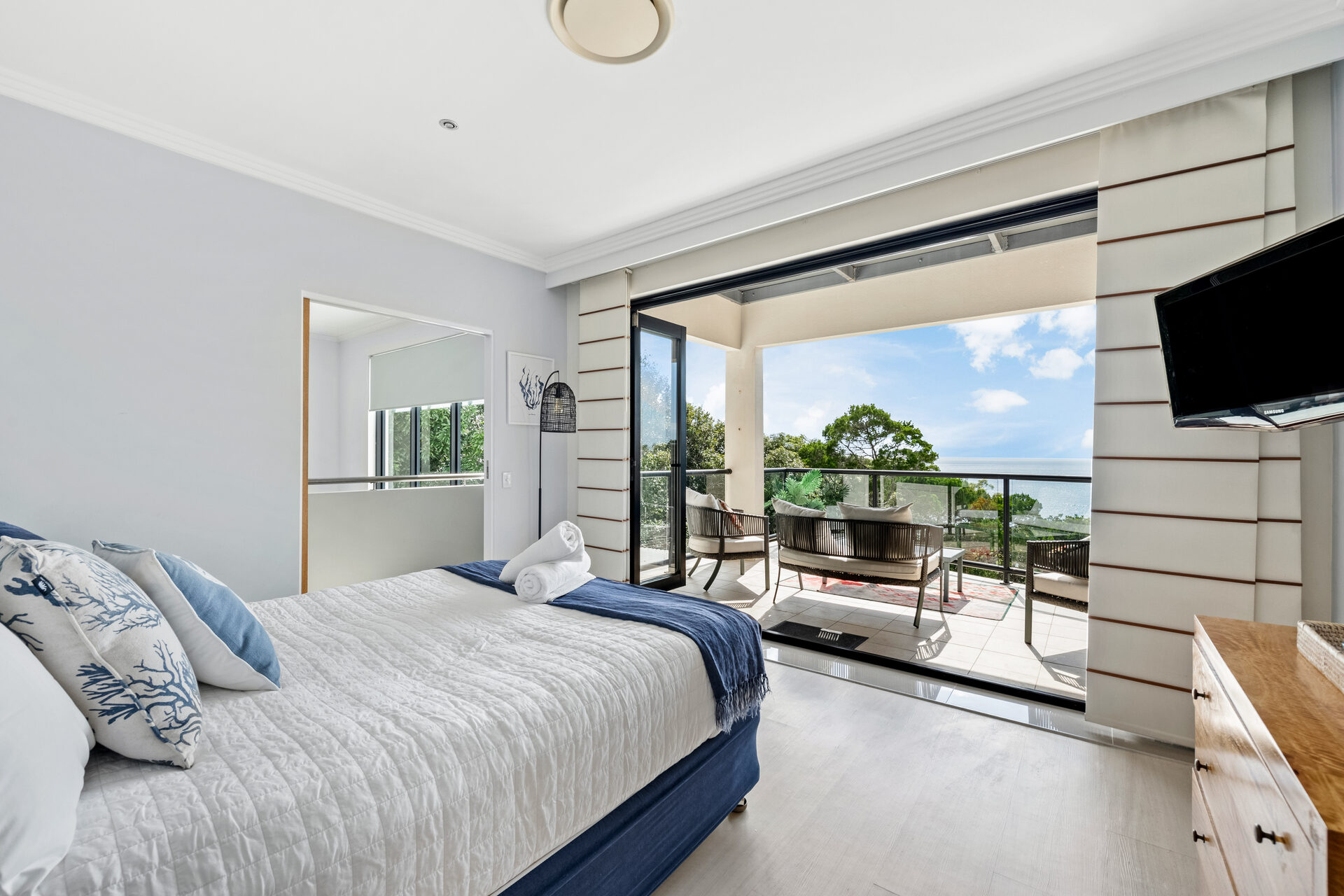 Master bedroom with private deck access and ocean views