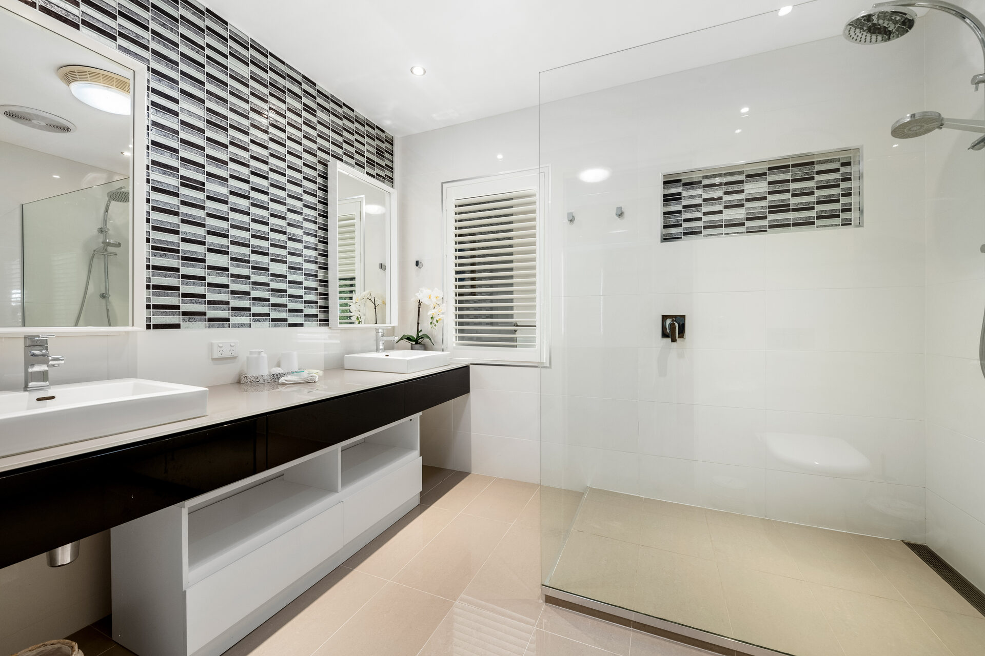 Ensuite with dual vanity, mosaic tile and rain shower